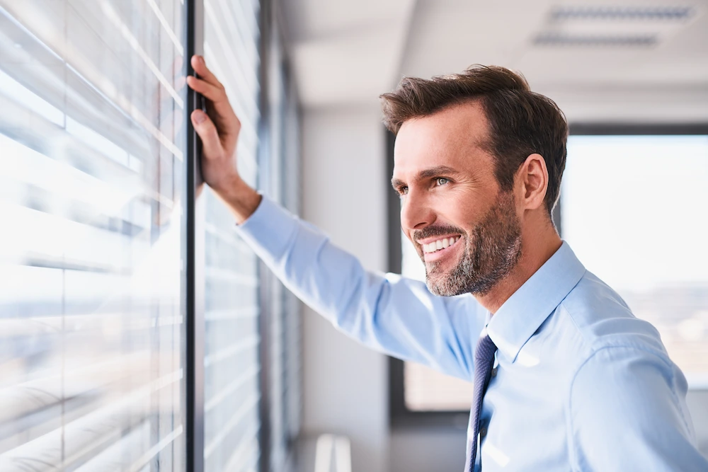 Confident business man raising his arm up